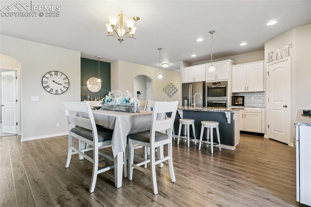 Image 10 of 50: The open floor plan between the dining area, kitchen, and living room allow