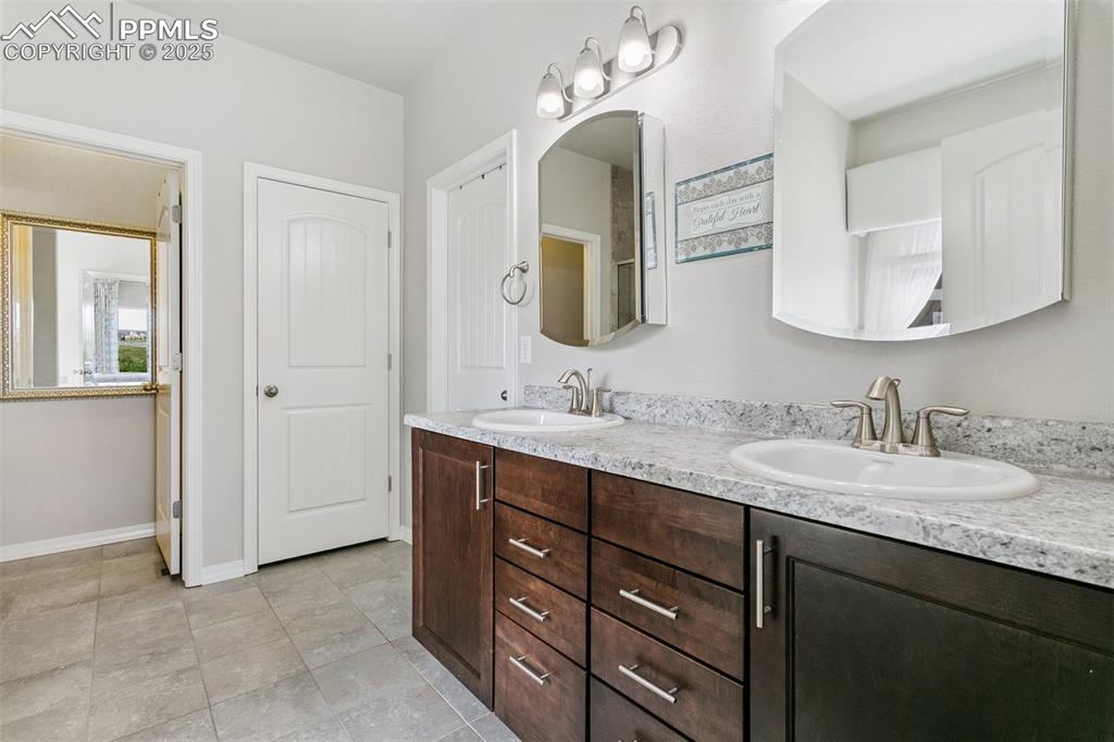 Image 20 of 50: Spacious 5-piece primary bathroom featuring double vanity, walk-in closet,