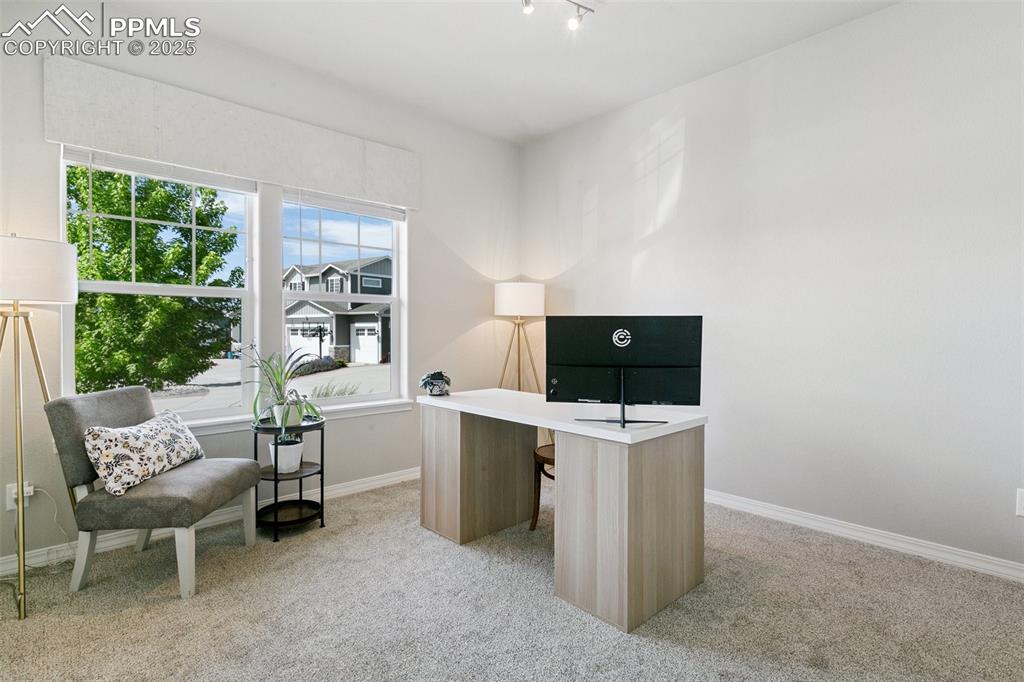 Image 22 of 50: Main level bedroom currently utilized as a home office