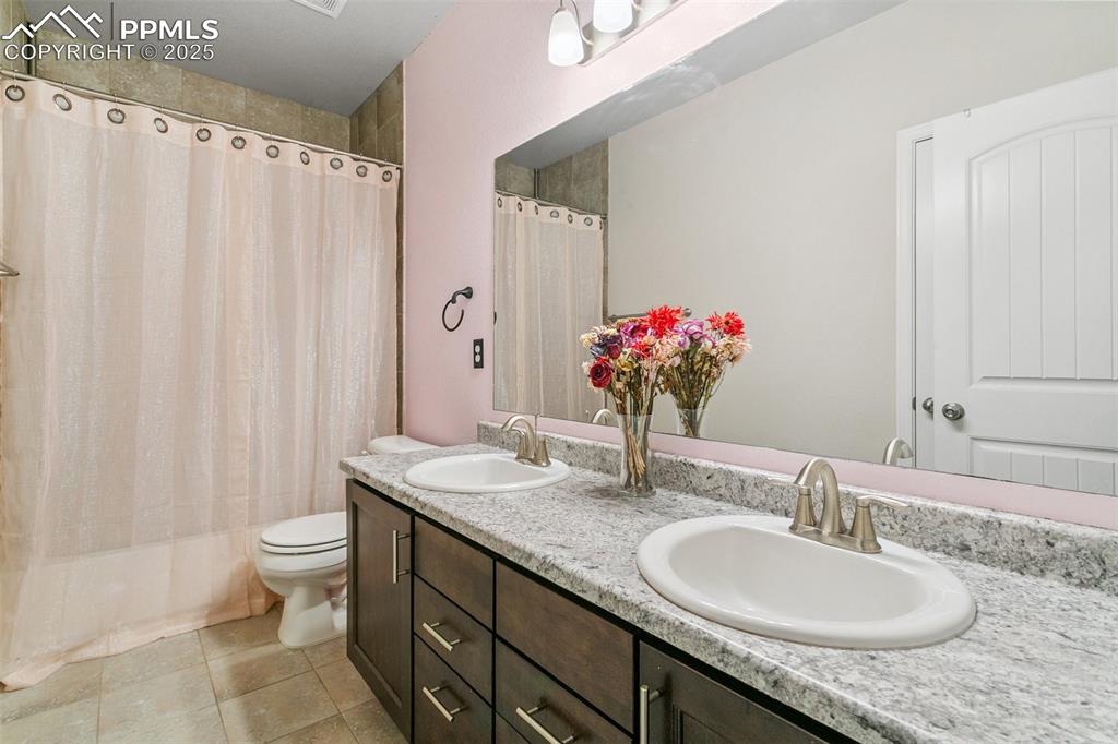 Image 29 of 50: Spacious full bathroom featuring a double vanity and lots of storage space