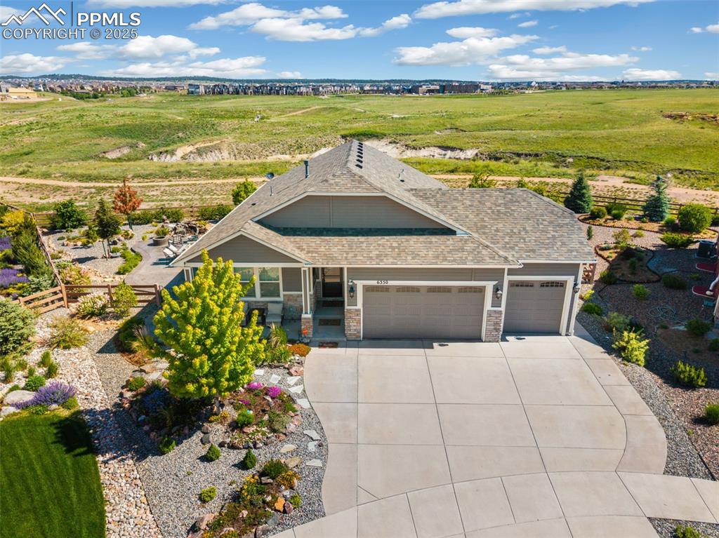 Image 3 of 50: Showcase your green thumb or entertain on the patio that wraps around the s