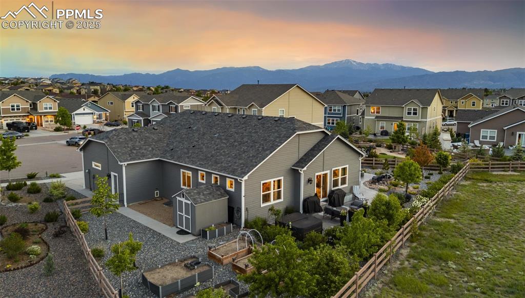 Image 31 of 50: Gorgeous backyard featuring mountain views, raised garden beds, patio space