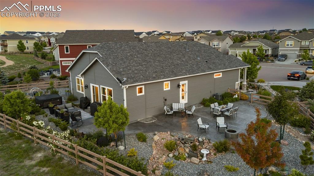 Image 32 of 50: Entertain on the spacious patio featuring a built-in firepit