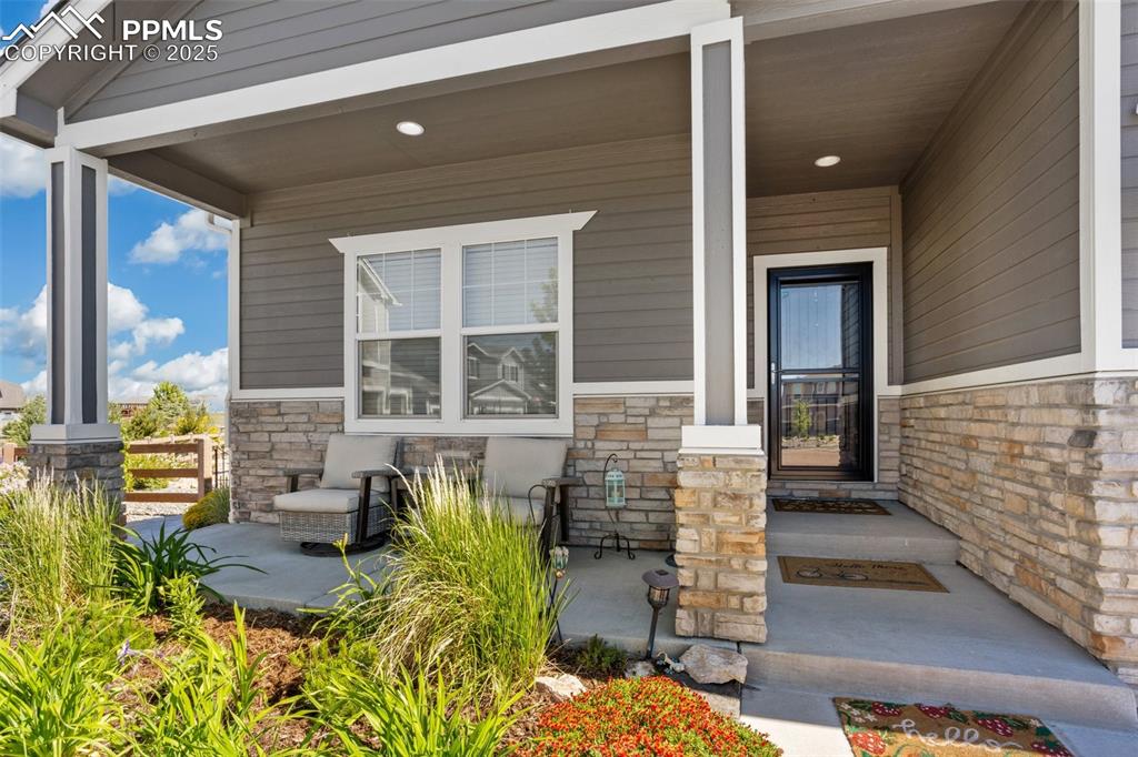 Image 5 of 50: Enjoy your morning coffee on the covered front patio