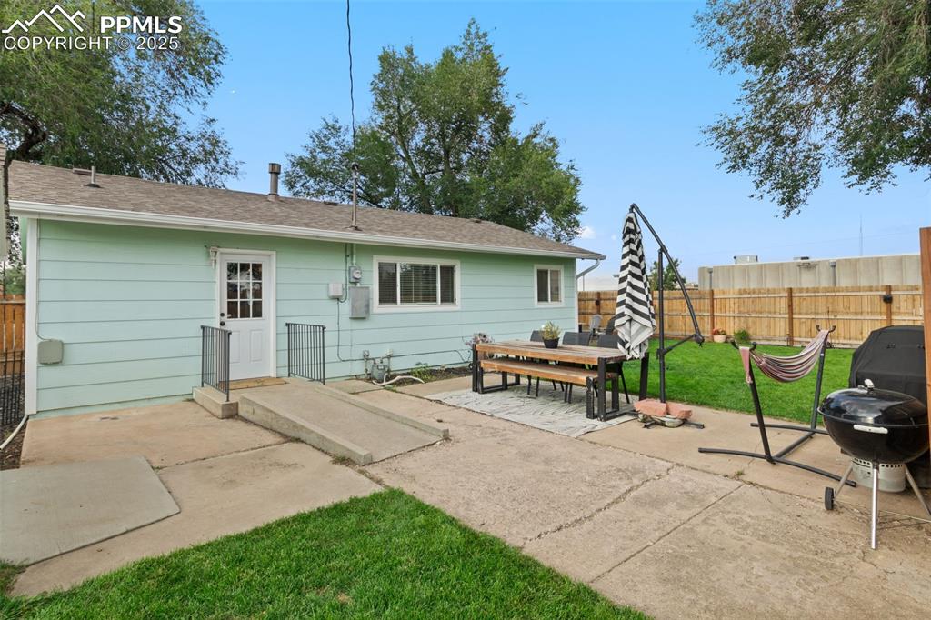 Image 22 of 34: VIEW OF BACK OF HOME & DOOR OFF KITCHEN