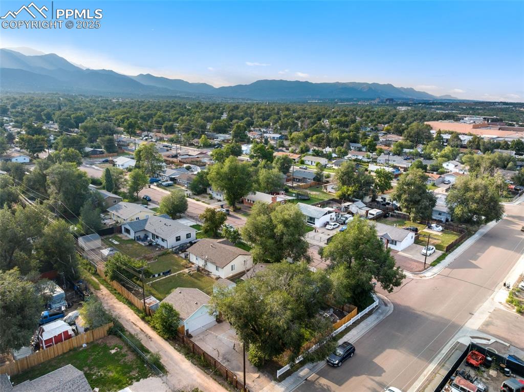 Image 31 of 34: AERIAL VIEW FROM BACK OF HOME SHOWING GARAGE & MOUNTAINS