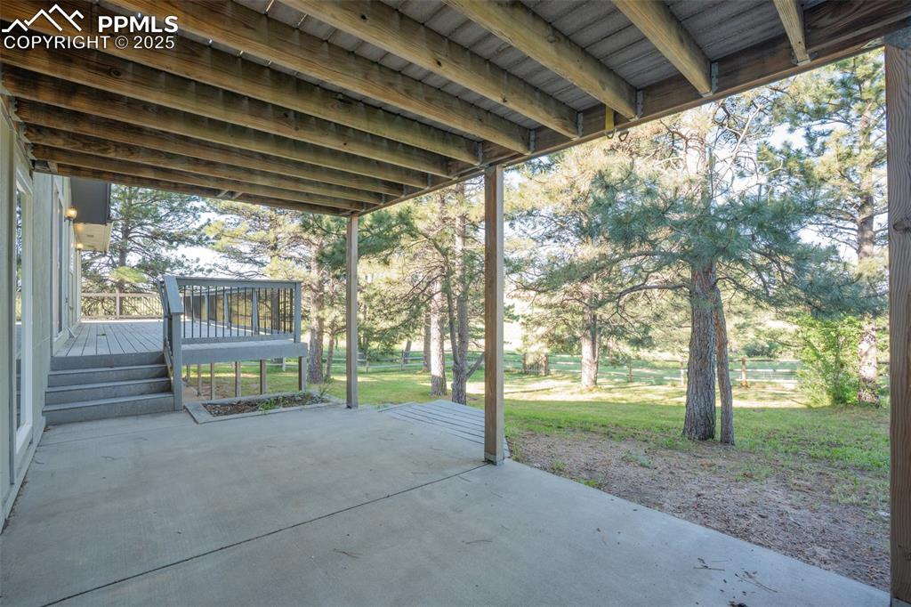 Image 24 of 46: View of patio with a deck