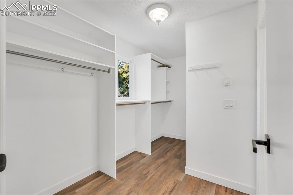 Image 31 of 46: Walk in closet featuring wood finished floors