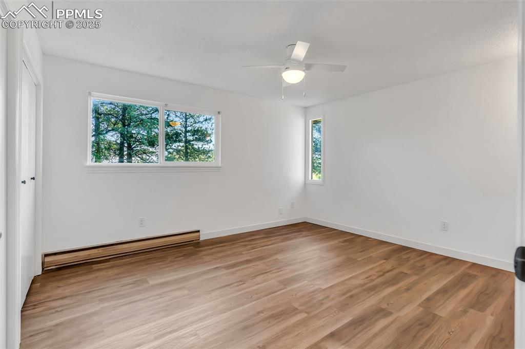 Image 35 of 46: Empty room featuring plenty of natural light, a baseboard heating unit, lig