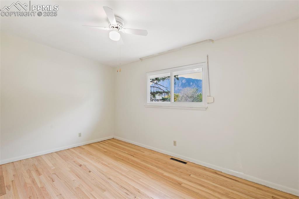 Image 14 of 35: Spare room with light wood-style floors and a ceiling fan