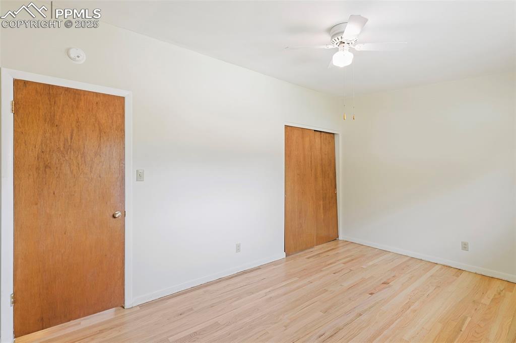 Image 15 of 35: Spare room with wood finished floors and ceiling fan