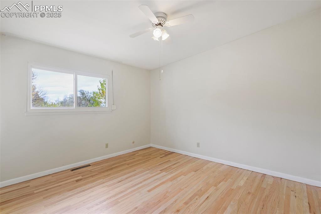 Image 16 of 35: Spare room with light wood-style flooring and a ceiling fan