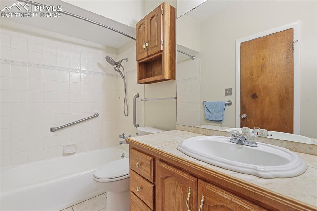Image 18 of 35: Full bathroom with shower / bath combination, vanity, and light tile patter