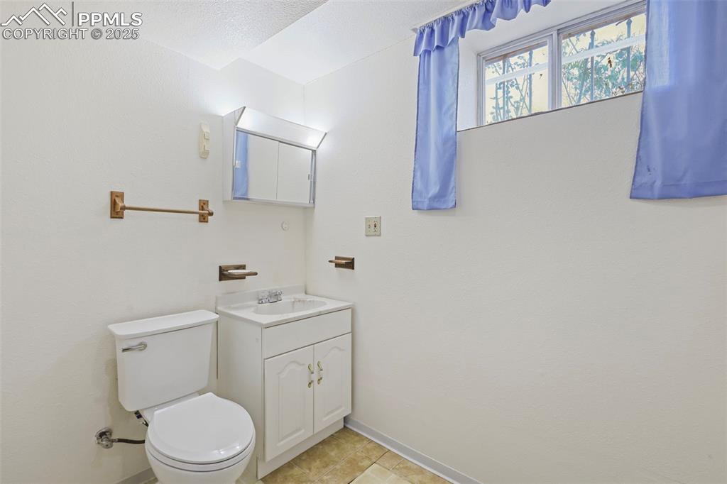 Image 24 of 35: Bathroom with vanity and light tile patterned floors