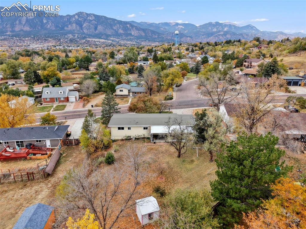 Image 31 of 35: Aerial view of residential area with a mountainous background