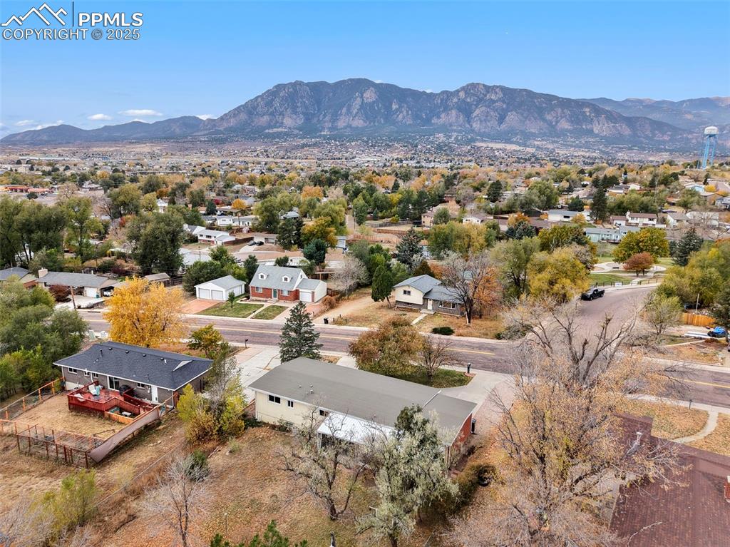 Image 32 of 35: Aerial view of residential area with a mountainous background