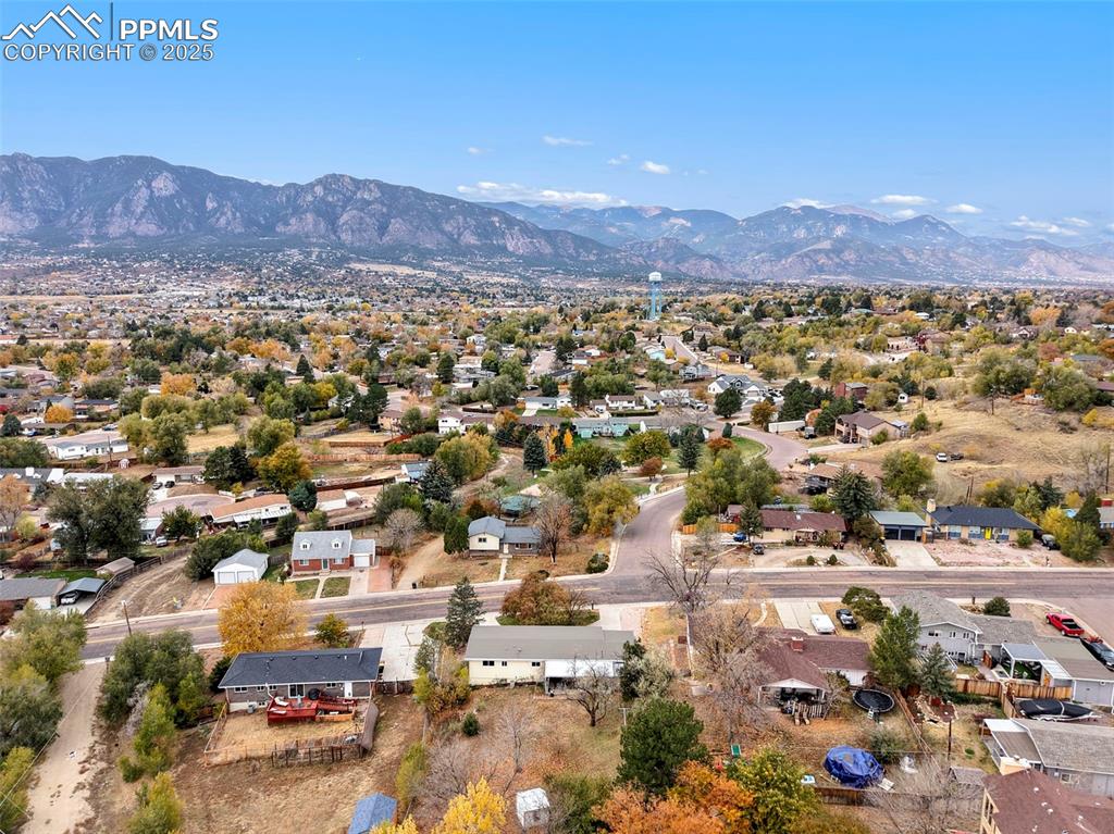 Image 33 of 35: Aerial view of residential area featuring a mountain backdrop