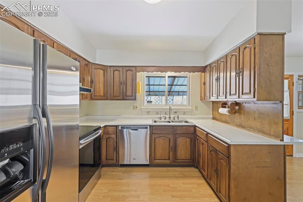 Image 9 of 35: Kitchen featuring appliances with stainless steel finishes, light counterto