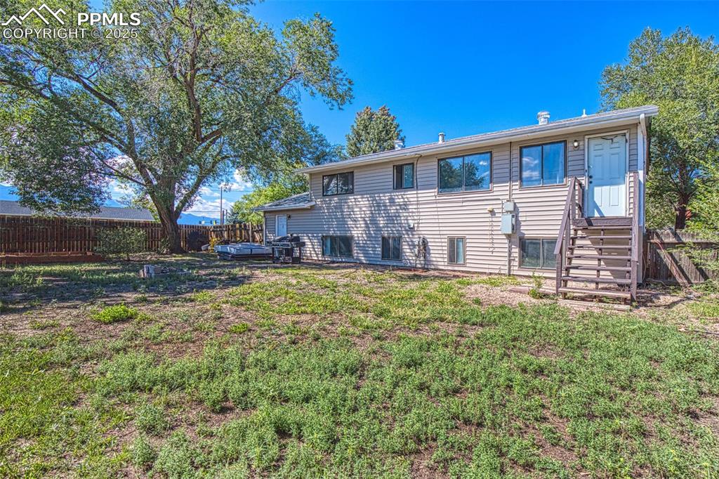 Image 28 of 36: Back of house and backyard