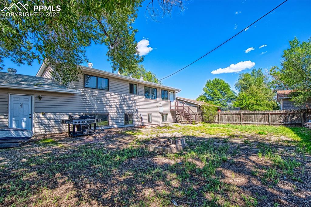 Image 29 of 36: Back of house and yard