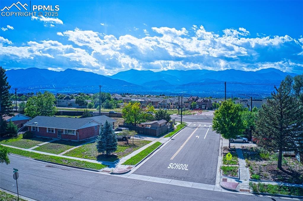 Image 34 of 36: View of mountain background featuring nearby suburban area