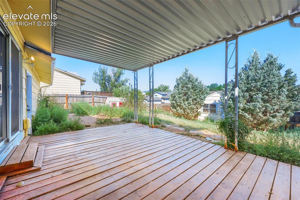 Image 34 of 38: Covered deck featuring wood flooring and metal support beams