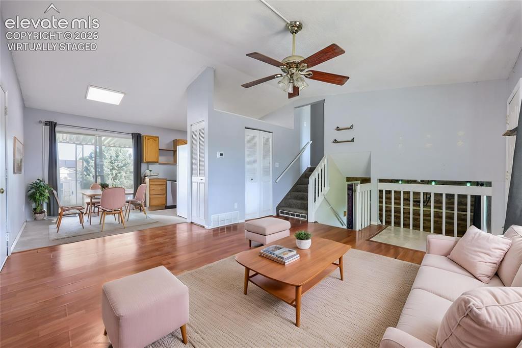 Image 7 of 38: Virtually Staged 
Open-concept living area featuring wood-finish flooring,