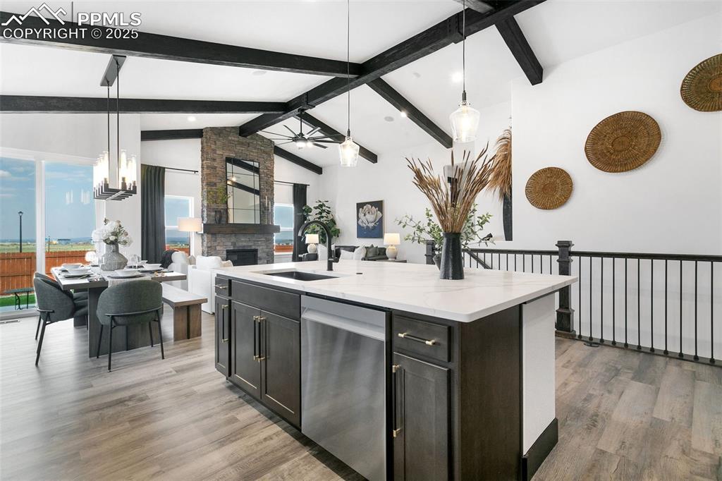Image 11 of 22: Kitchen featuring decorative light fixtures, stainless steel dishwasher, li