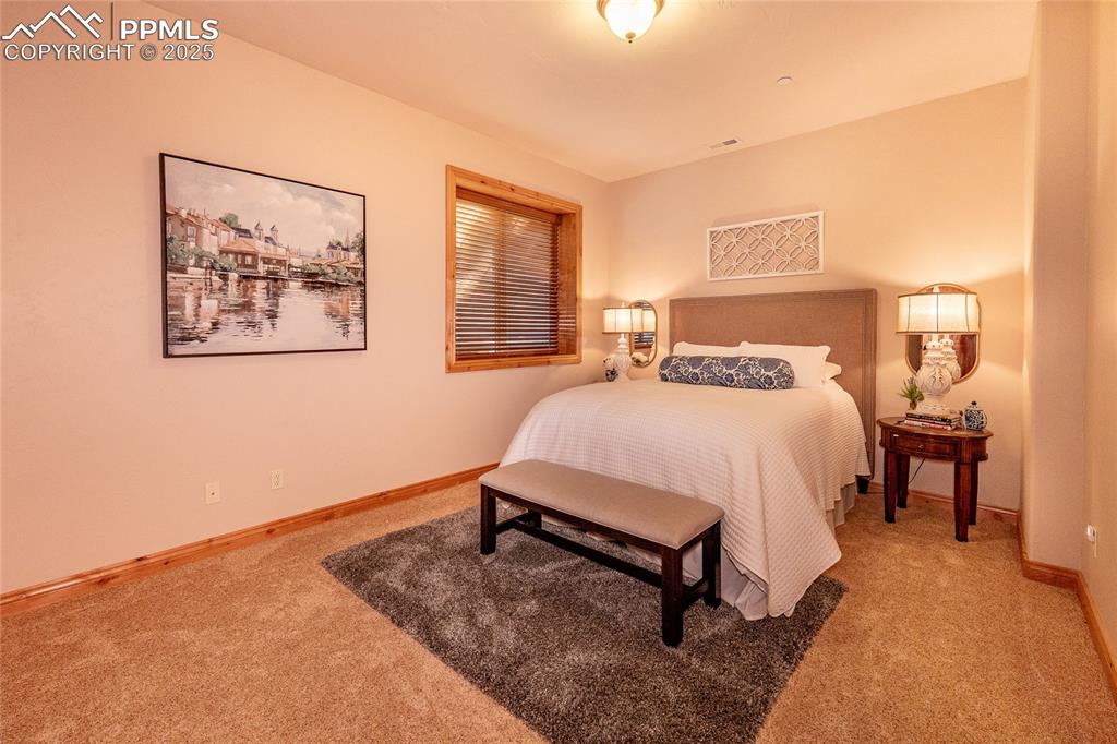 Image 25 of 47: Bedroom featuring light colored carpet