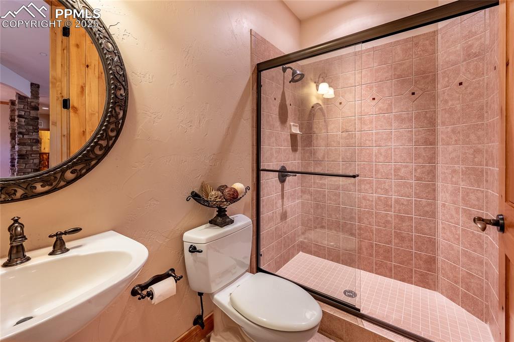 Image 27 of 47: Bathroom featuring a textured wall and a shower stall