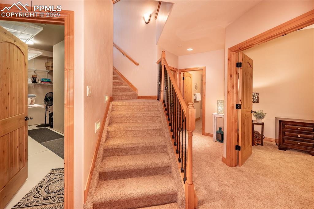 Image 35 of 47: Stairs featuring baseboards and carpet floors