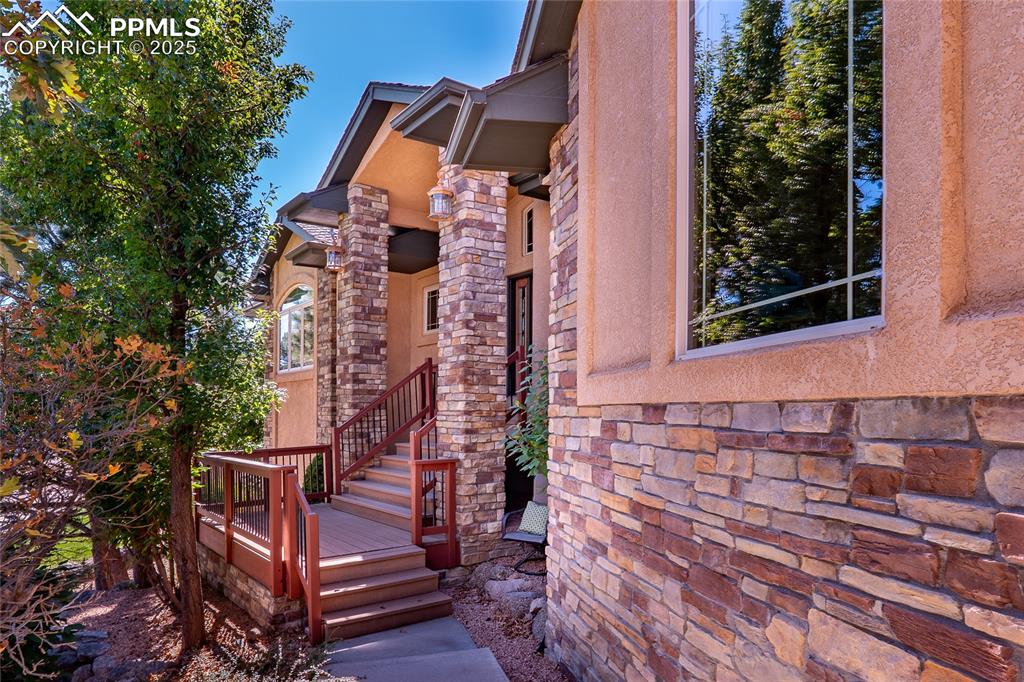 Image 37 of 47: View of exterior entry with stone siding