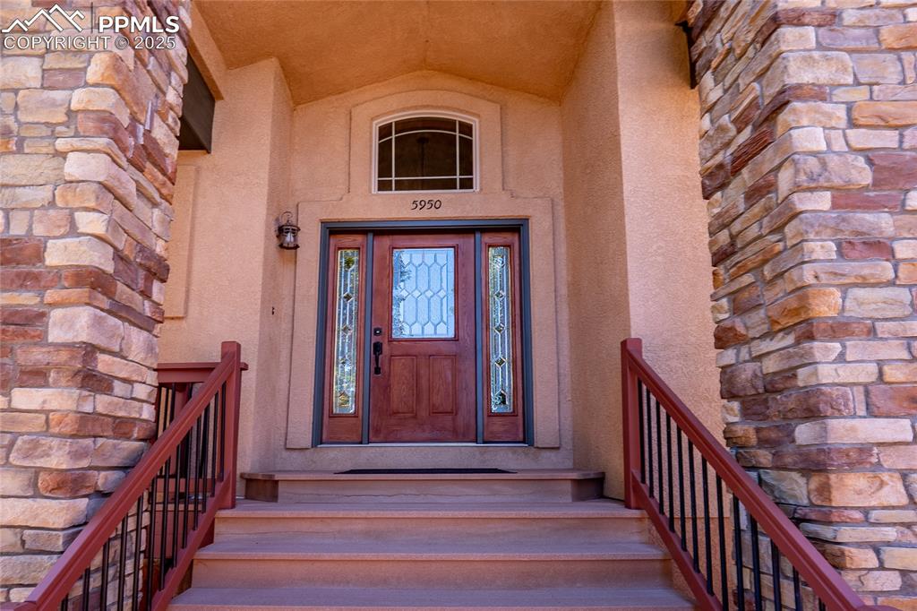 Image 38 of 47: Property entrance featuring stucco siding