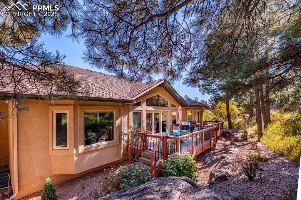 Image 43 of 47: Rear view of house with stucco siding and a deck