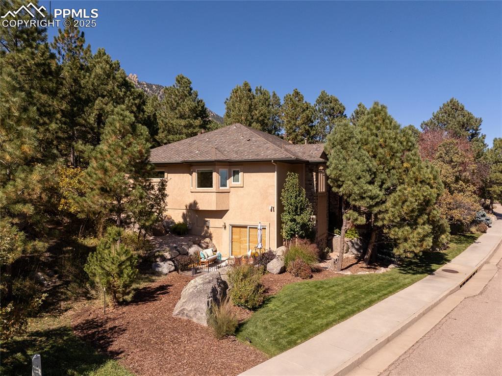 Image 6 of 47: Side of front of house with stucco siding and a front yard