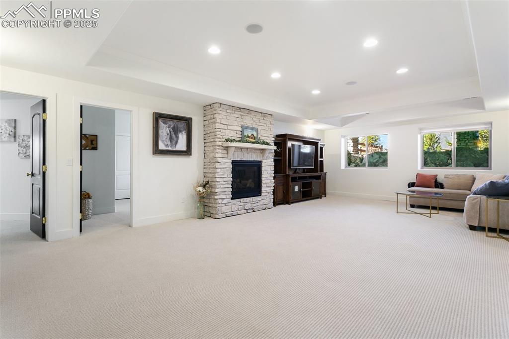 Image 35 of 49: Living room featuring baseboards, carpet flooring, and a raised ceiling
