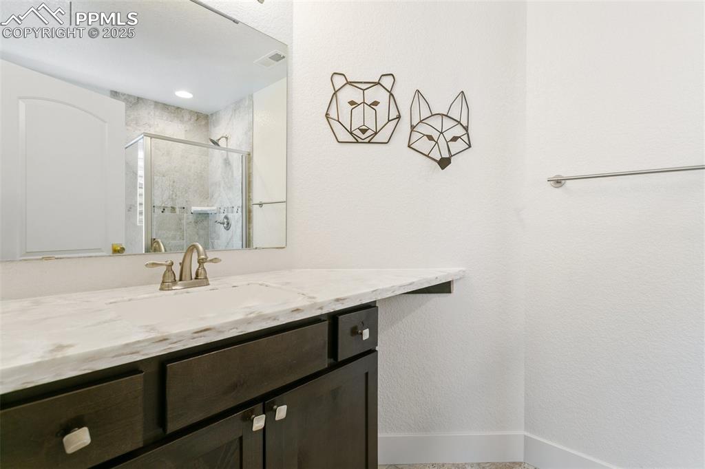 Image 39 of 49: Full bathroom featuring visible vents, baseboards, vanity, and a stall show