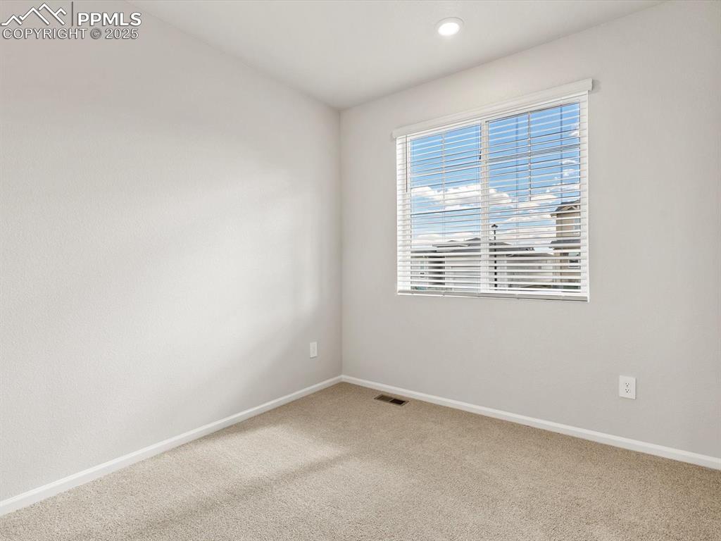 Image 13 of 23: Carpeted empty room with baseboards