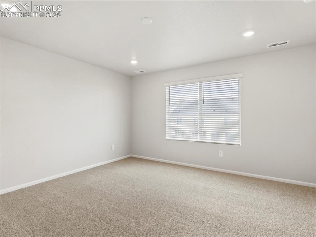 Image 15 of 23: Unfurnished room with light carpet and recessed lighting