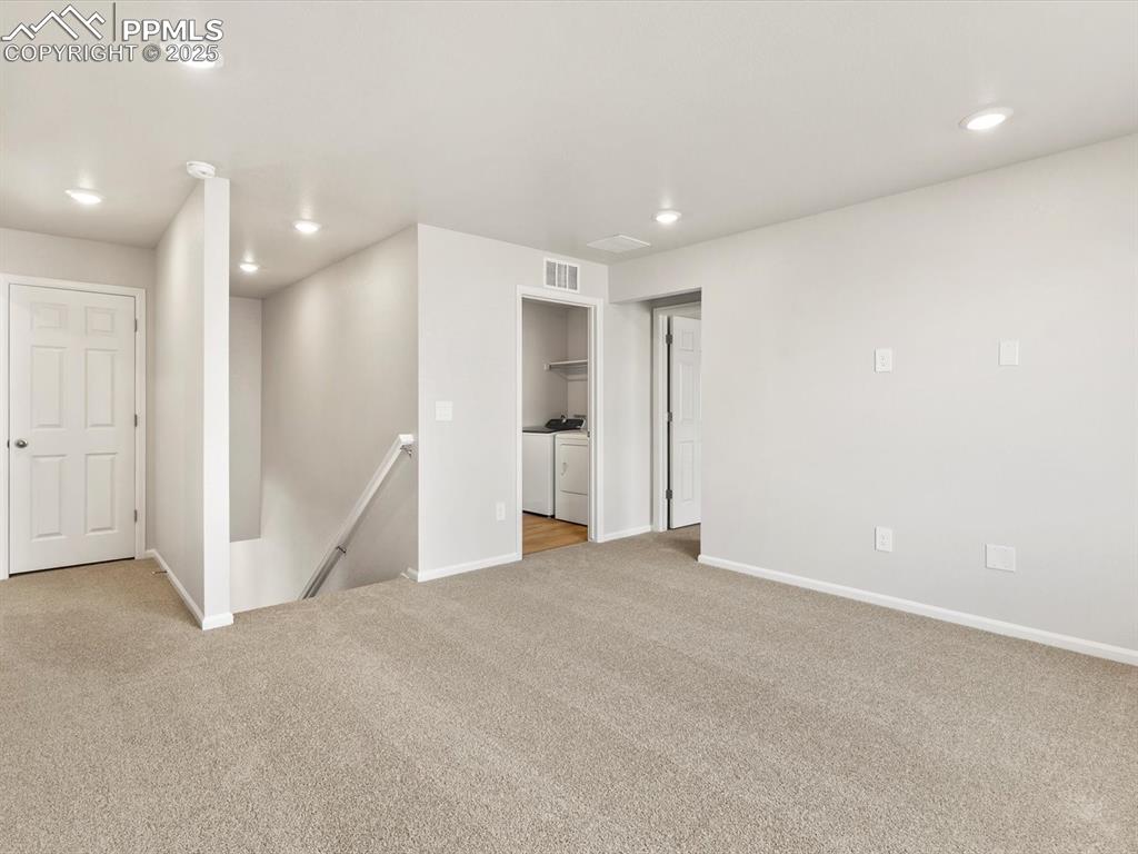 Image 20 of 23: Unfurnished room featuring recessed lighting, light colored carpet, and was