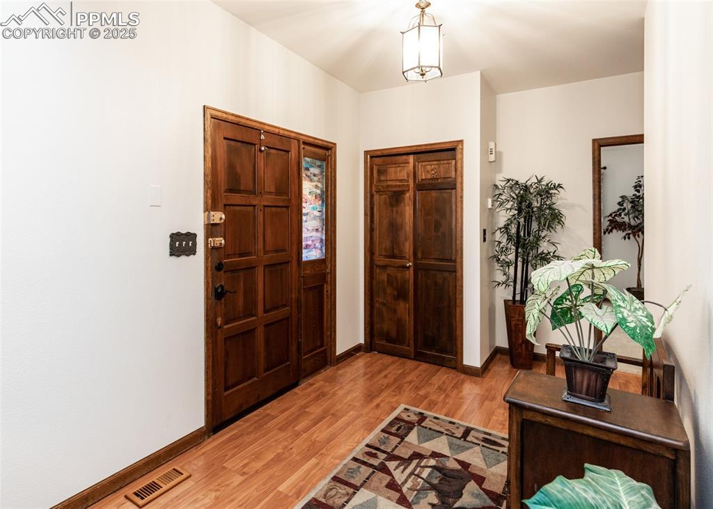 Image 11 of 37: Entrance foyer with light wood finished floors and baseboards