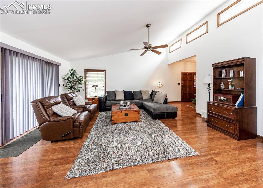 Image 13 of 37: Living area with outdoor sliding glass door to back deck