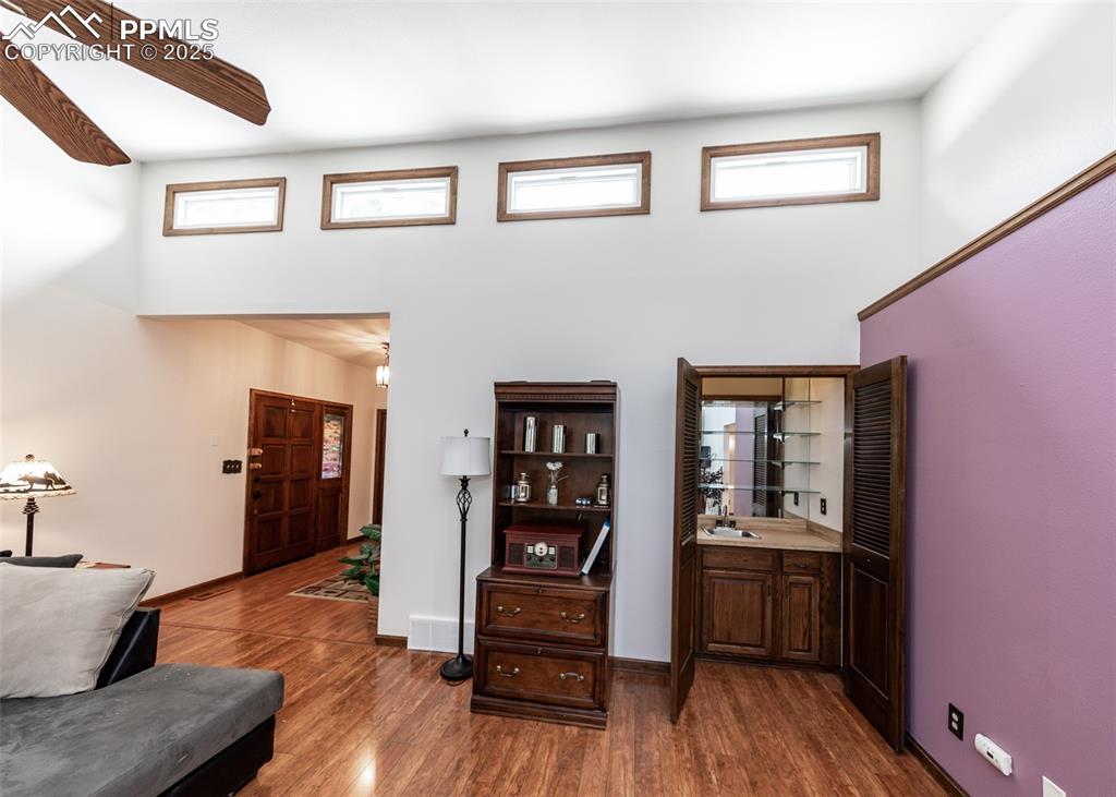 Image 14 of 37: Living room showing the wet bar in the corner