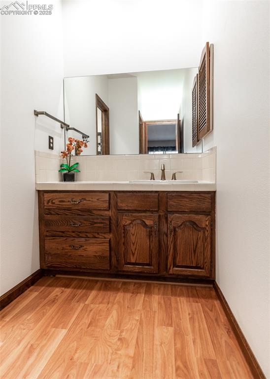 Image 29 of 37: Master bathroom featuring wood finished floors, decorative backsplash, and 