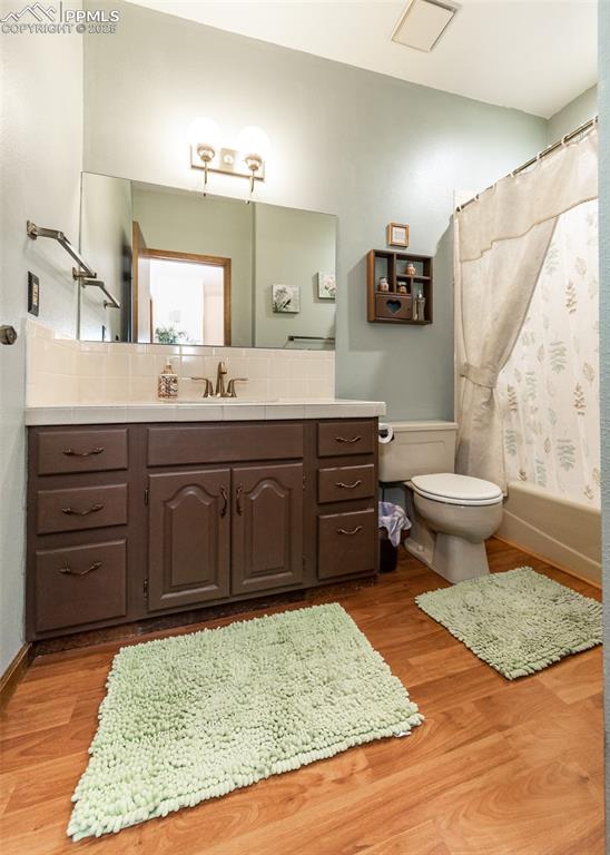 Image 33 of 37: Full bathroom featuring vanity, wood finished floors, and shower/bath tub c