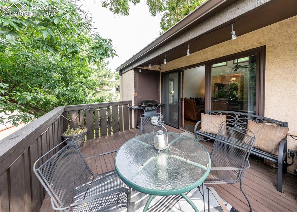 Image 36 of 37: Wooden terrace with area for grilling and outdoor dining space