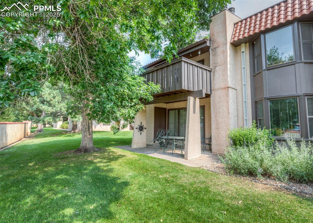 Image 5 of 37: View of grassy yard featuring a patio and a balcony