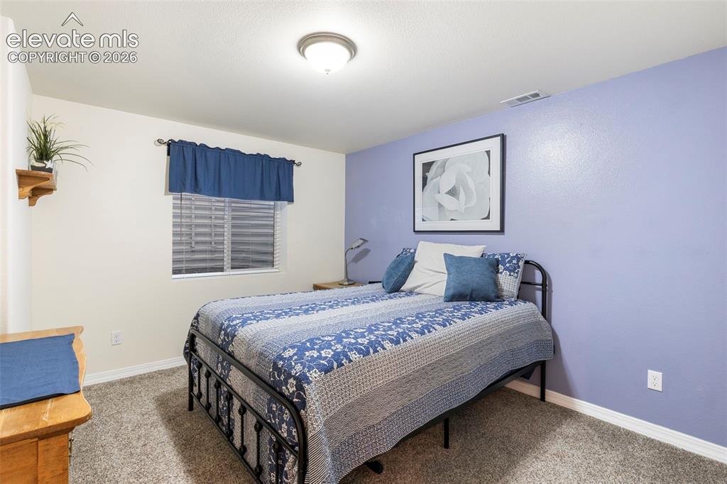 Image 23 of 28: Plush carpet flooring, a window with blinds, and a flush mount ceiling ligh