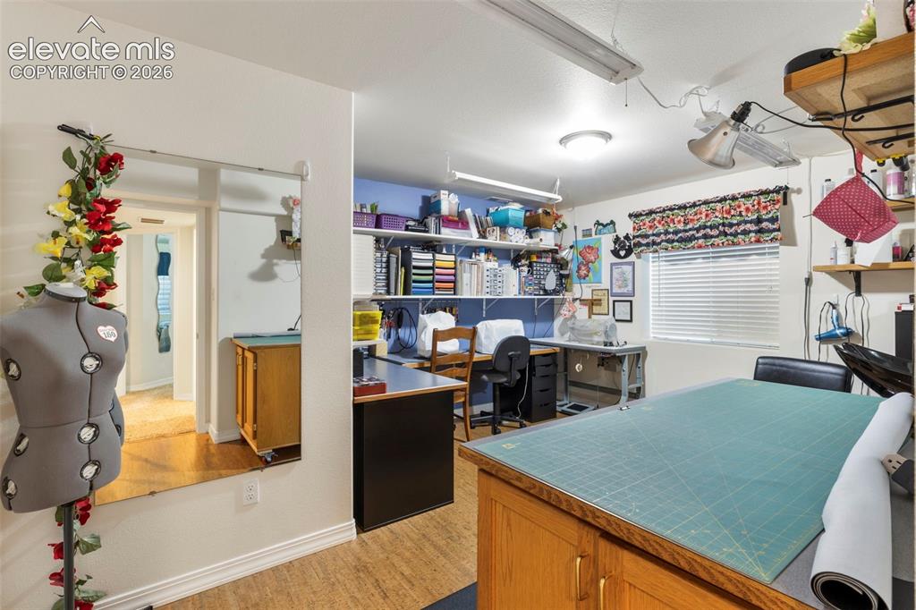 Image 25 of 28: Room featuring wood-finish flooring, a window with blinds, and built-in she