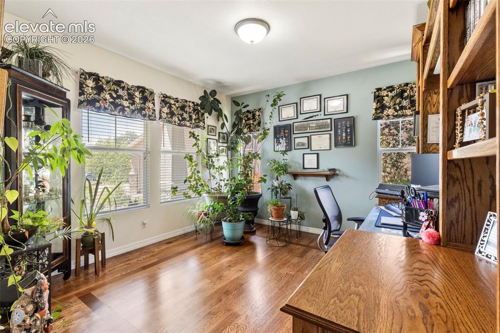 Image 4 of 28: Warm wood-finish flooring complements the light blue wall